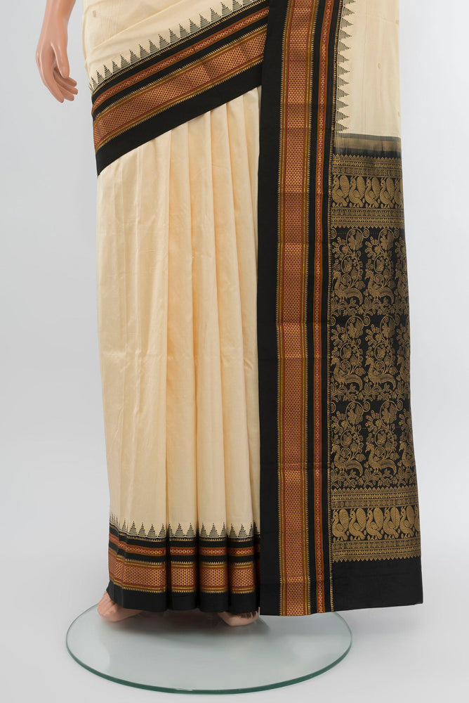 Pleats and pallu of Cream Narayanpet Silk Saree with Zari Butta on the body and Silk Border. 