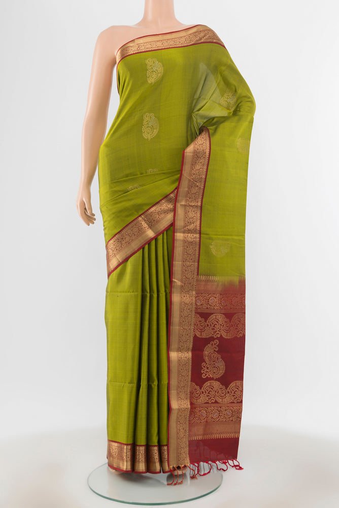 Light Green Soft Silk Saree with Zari Butta on the body and Silk Border.  displayed on a mannequin
