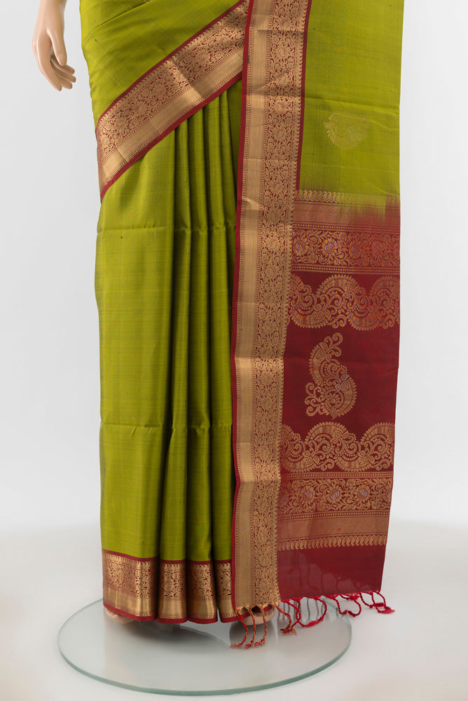 Pleats and pallu of Light Green Soft Silk Saree with Zari Butta on the body and Silk Border. 