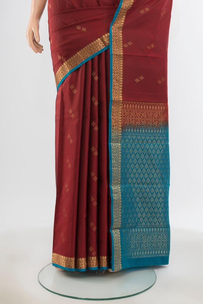 Pleats and pallu of Pure Silk Pure Zari Maroon Soft Saree with Zari Butta on the body and Silk Border. 