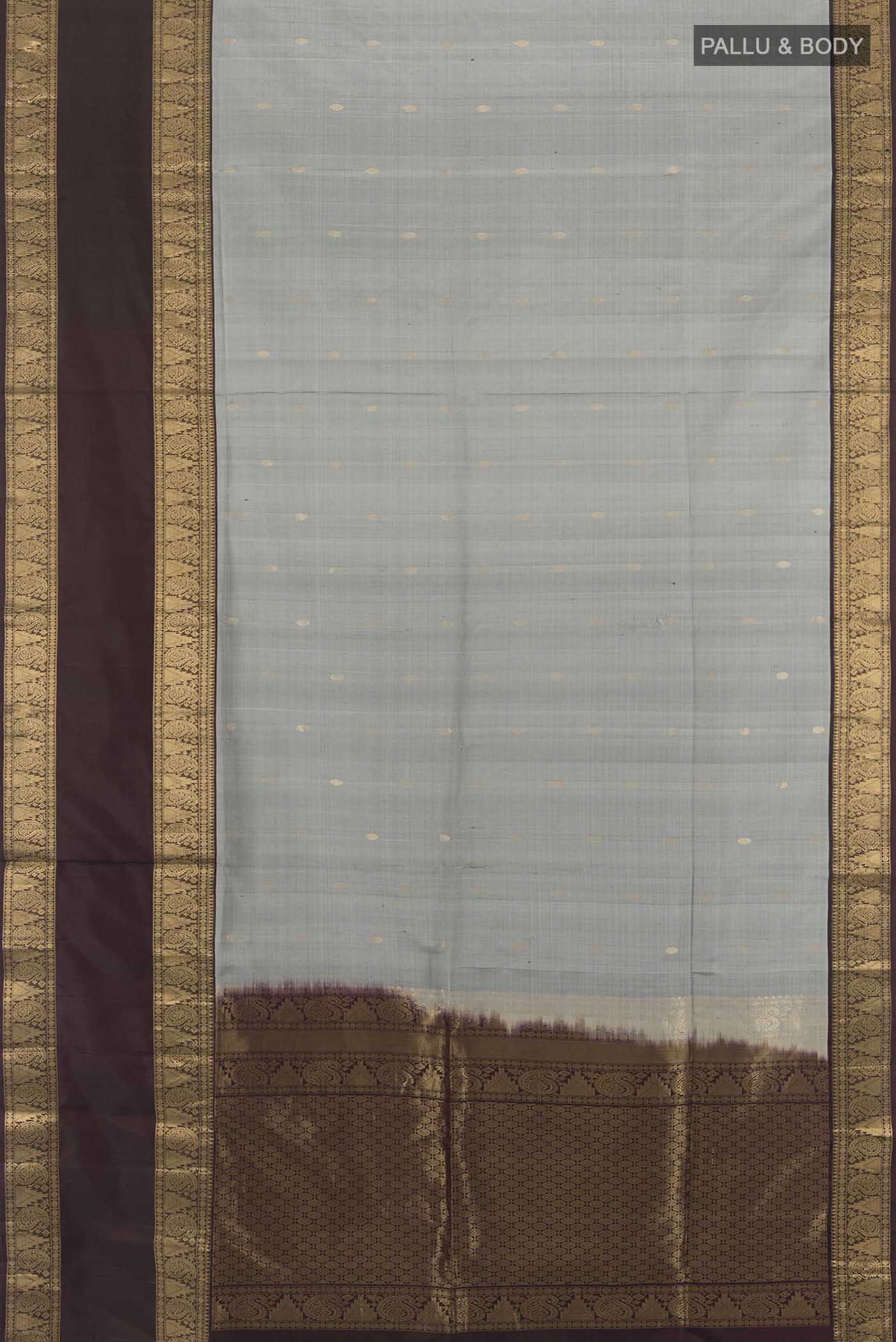 Flat view of Grey Soft Silk Saree with Zari Butta on the body and Zari Border. 