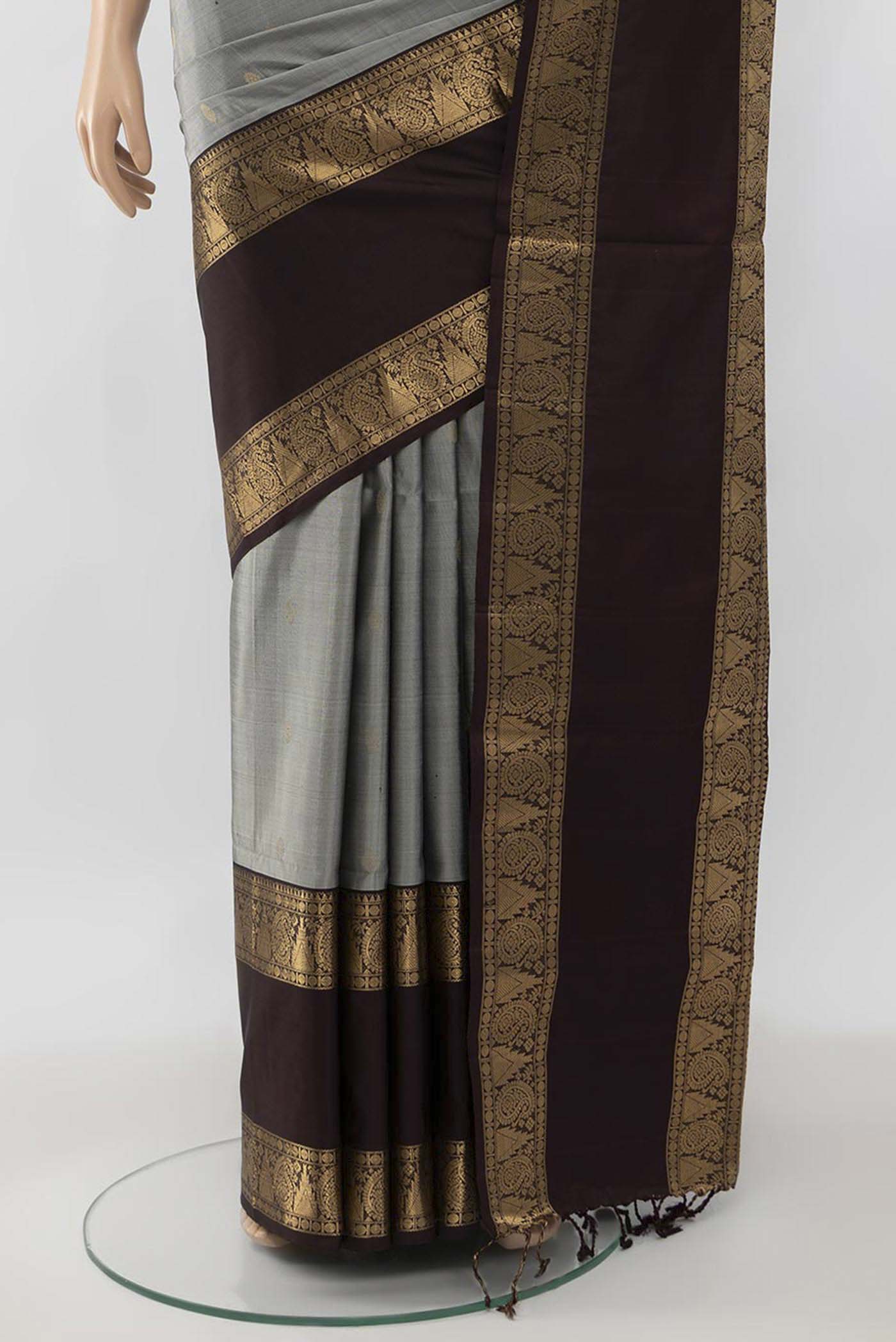 Pleats and pallu of Grey Soft Silk Saree with Zari Butta on the body and Zari Border. 