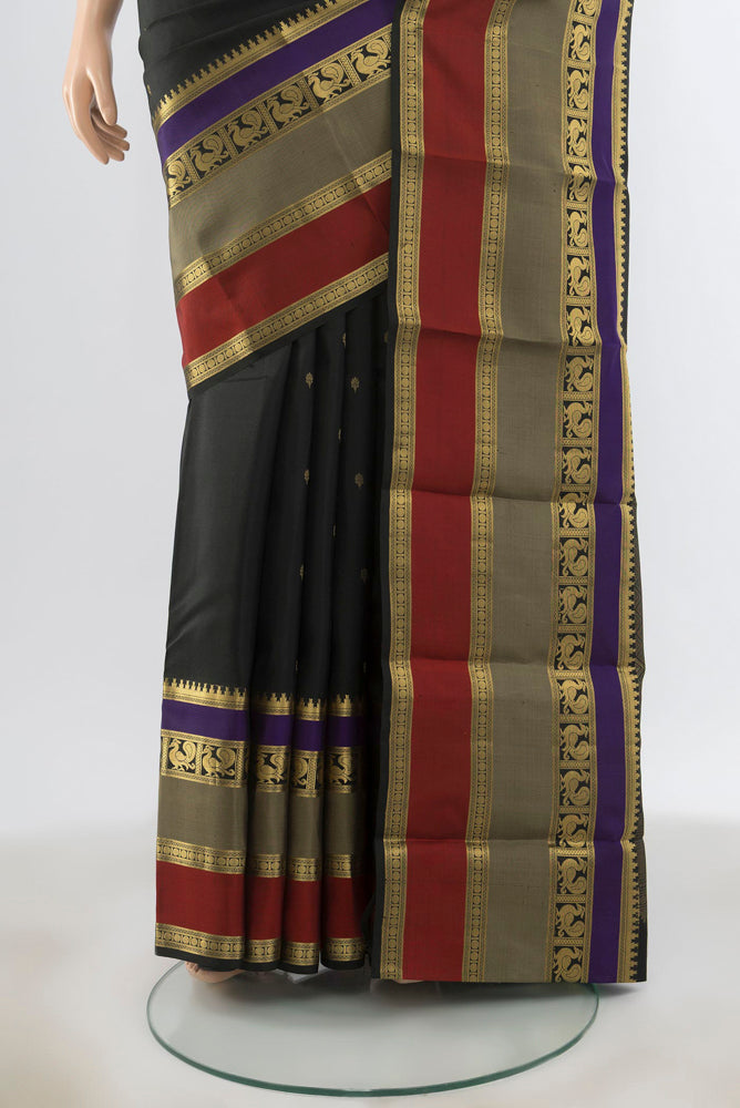 Pleats and pallu of Black Kanjivaram Silk Saree with Zari Butta on the body and Silk Border. 