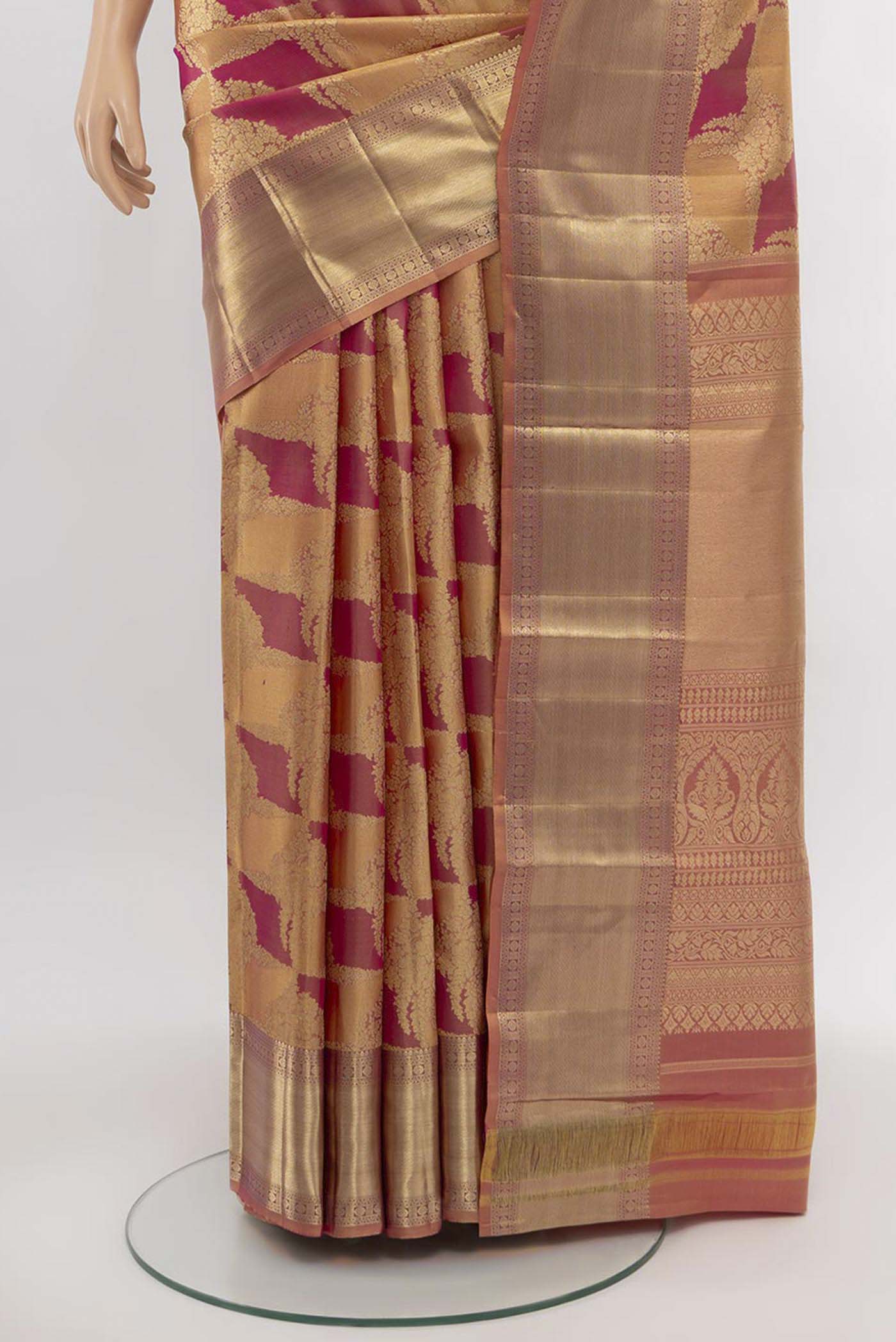Pleats and pallu of Golden Peach Kanjivaram Silk Saree with Zari Butta on the body and Silk Border. 