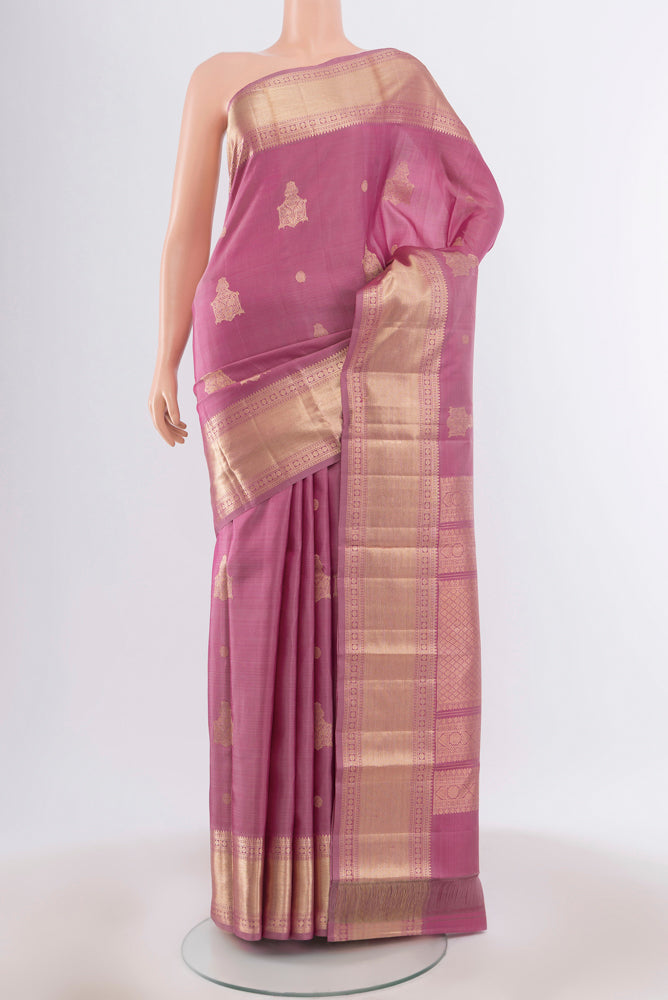 Bronze Kanjivaram Silk Saree with Zari Butta on the body and Silk Border.  displayed on a mannequin