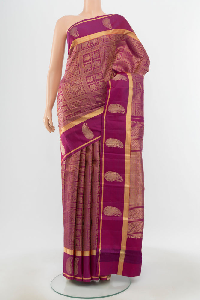 Pure Silk Pure Zari Purple Kanchipuram Saree with Zari Butta on the body and Silk Border.  displayed on a mannequin