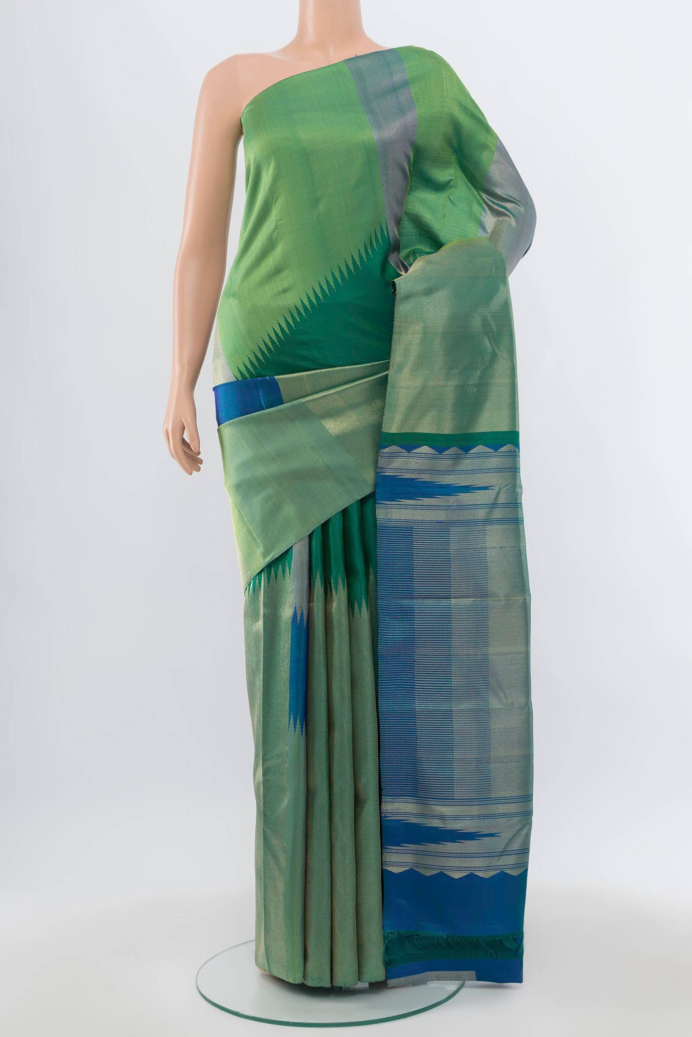 Green Kanchipuram Silk Saree with Zari Butta on the body and Silk Border.  displayed on a mannequin