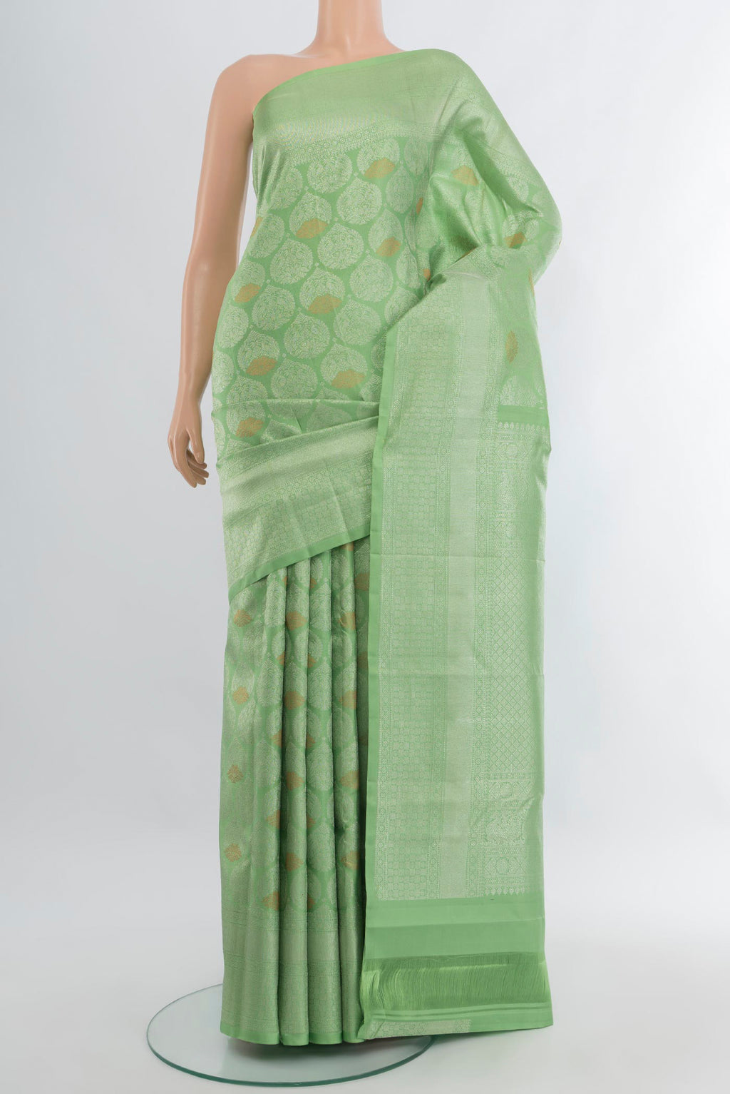 Pista Green Kanchipuram Silk Saree with Zari Brocade on the body and Zari Border.  displayed on a mannequin