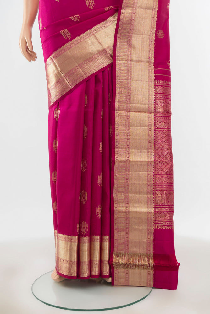 Pleats and pallu of Pure Silk Pure Zari Magenta Kanjivaram Saree with Zari Butta on the body and Silk Border. 