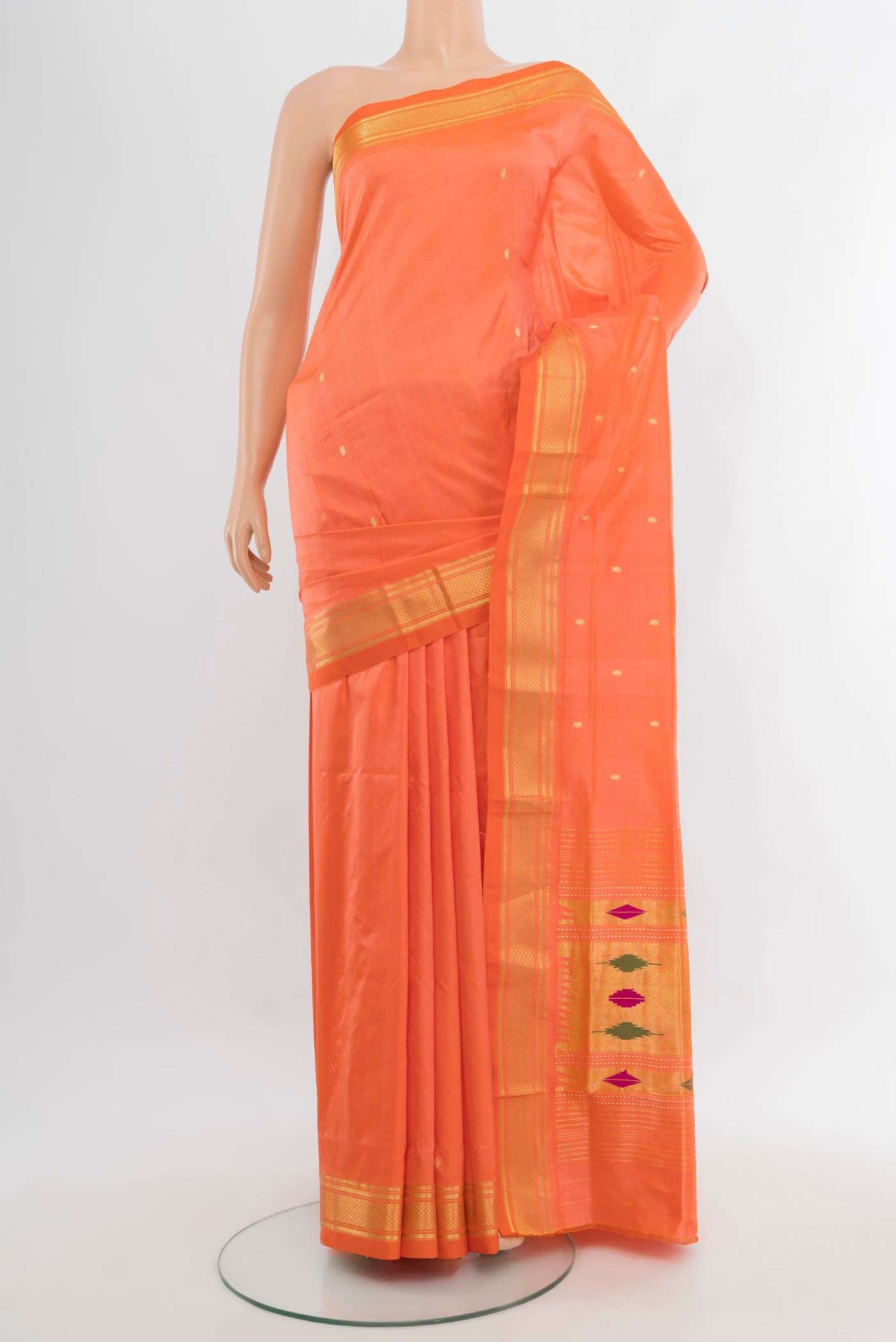 Coral Paithani Silk Saree with Zari Butta on the body and Zari Border.  displayed on a mannequin