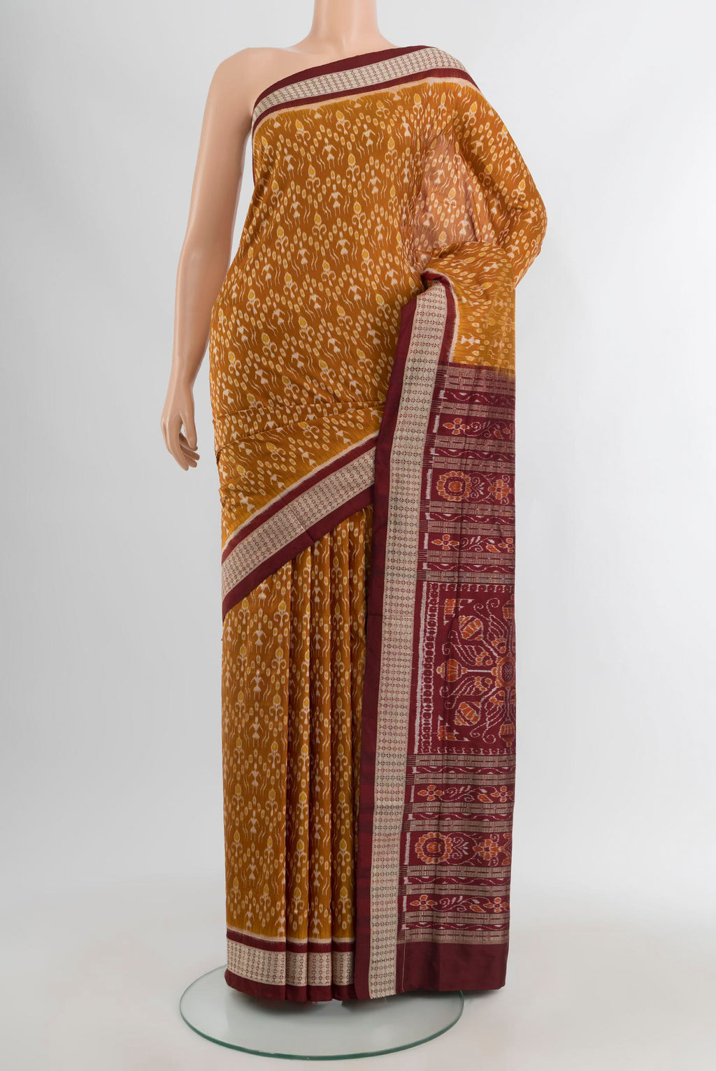 Mustard Orissa Silk Saree with Pure Ikat on the body and Thread Border.  displayed on a mannequin