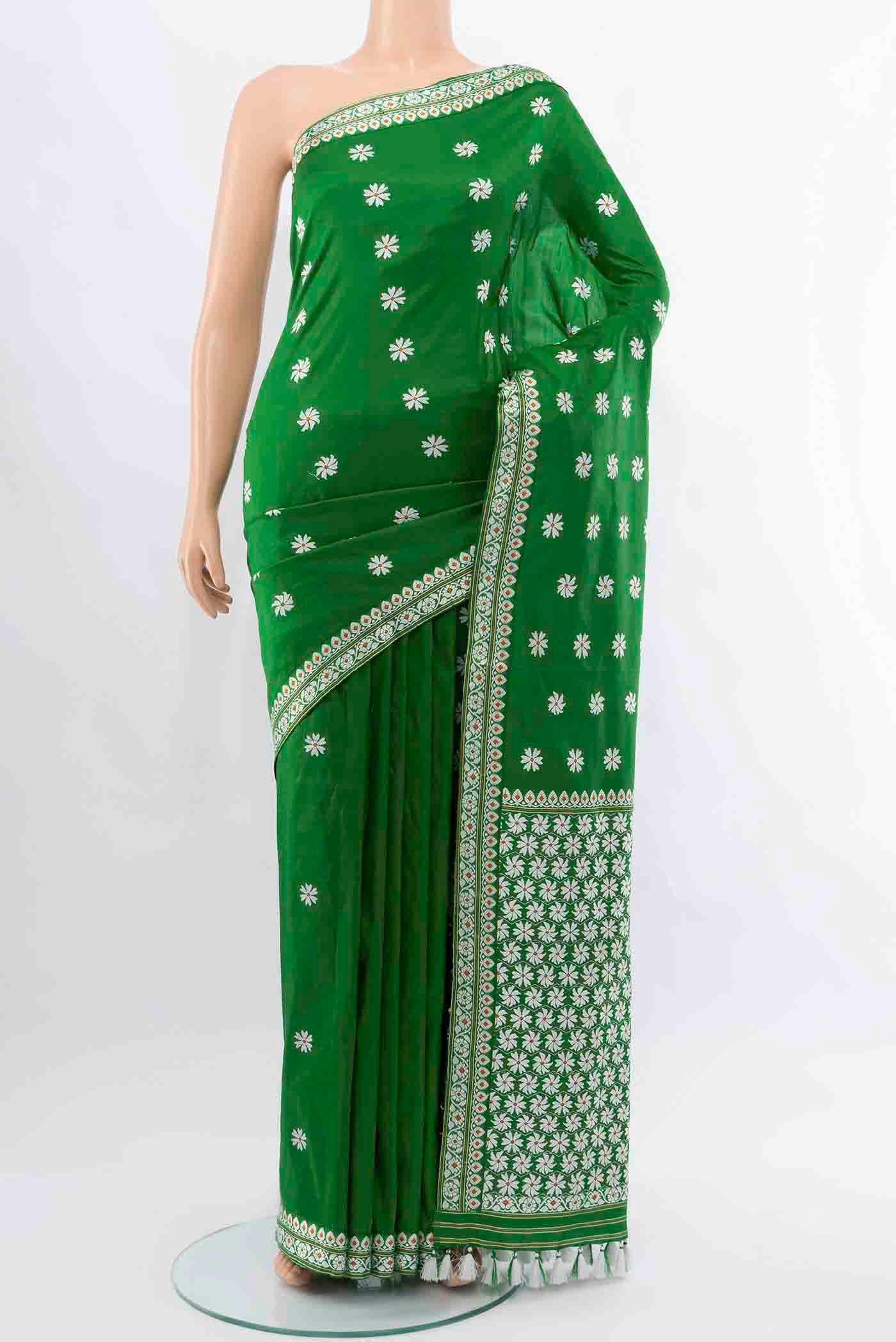 Bottle Green Assam Silk Saree with Thread Butta on the body and Silk Border displayed on a mannequin