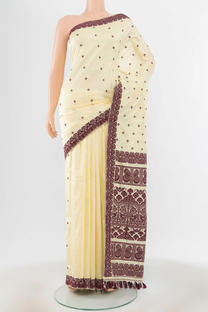 Cream Assam Silk Saree with Jacquard With Thread Butta on the body and Silk Border.  displayed on a mannequin