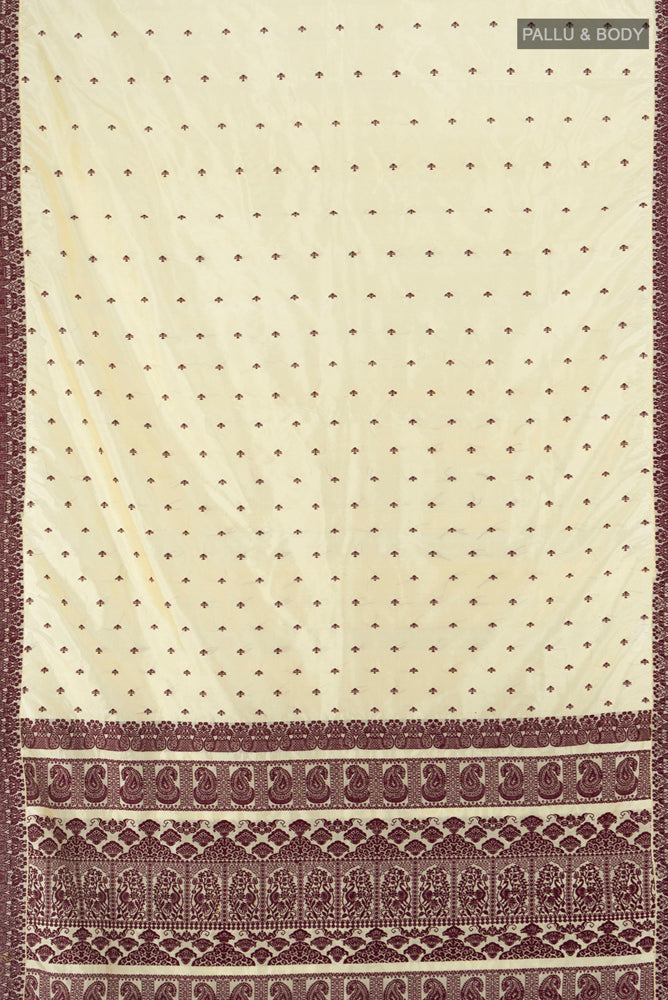 Flat view of Cream Assam Silk Saree with Jacquard With Thread Butta on the body and Silk Border. 