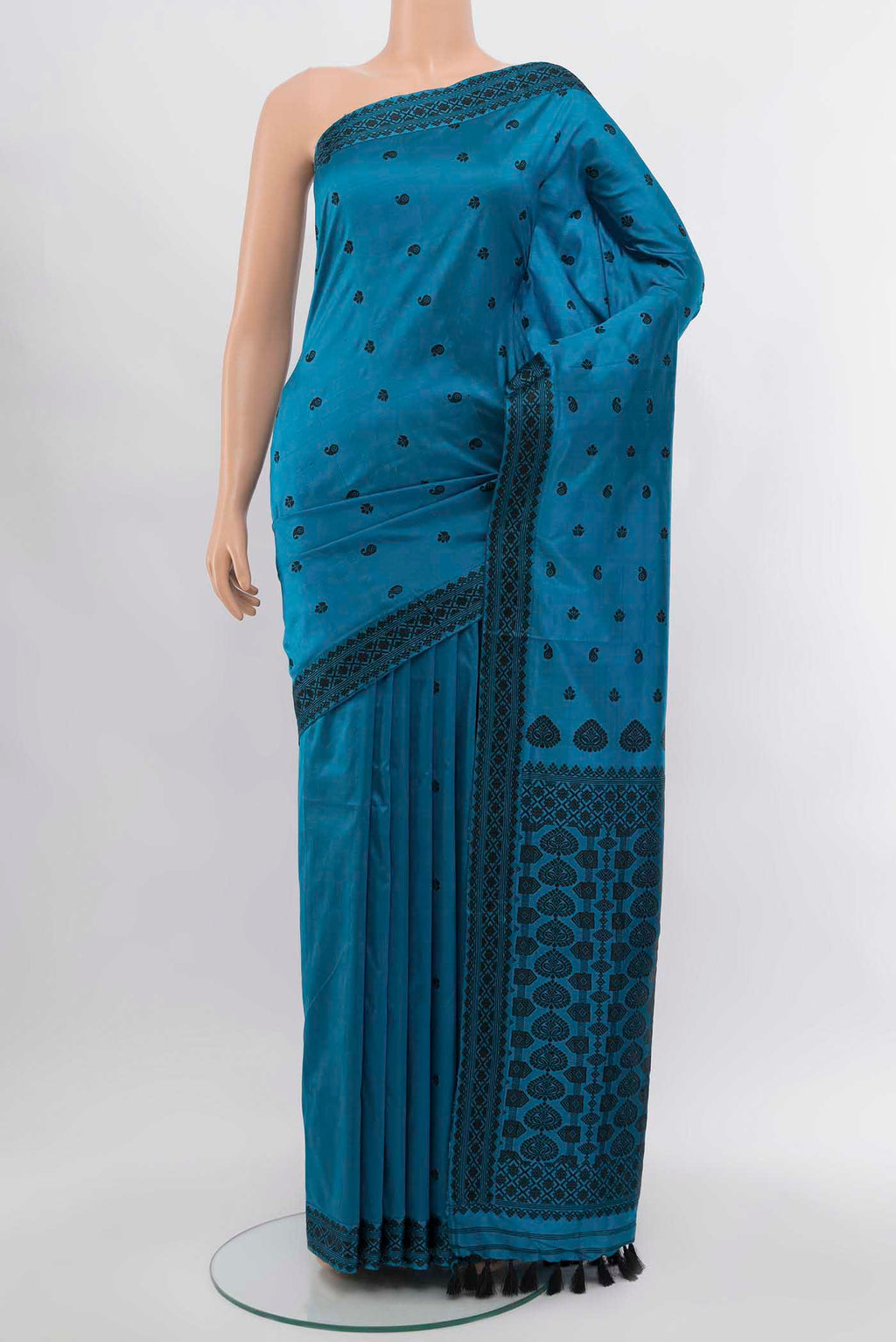 Light Blue Assam Silk Saree with Zari Butta on the body and Silk Border.  displayed on a mannequin