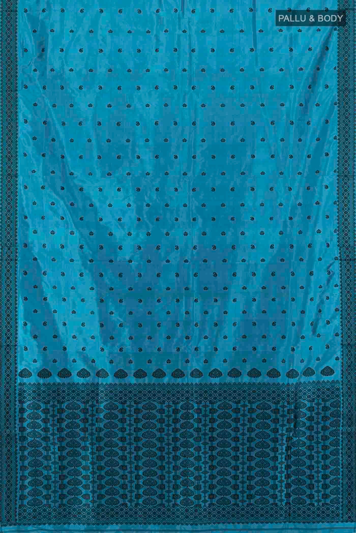 Flat view of Light Blue Assam Silk Saree with Zari Butta on the body and Silk Border. 