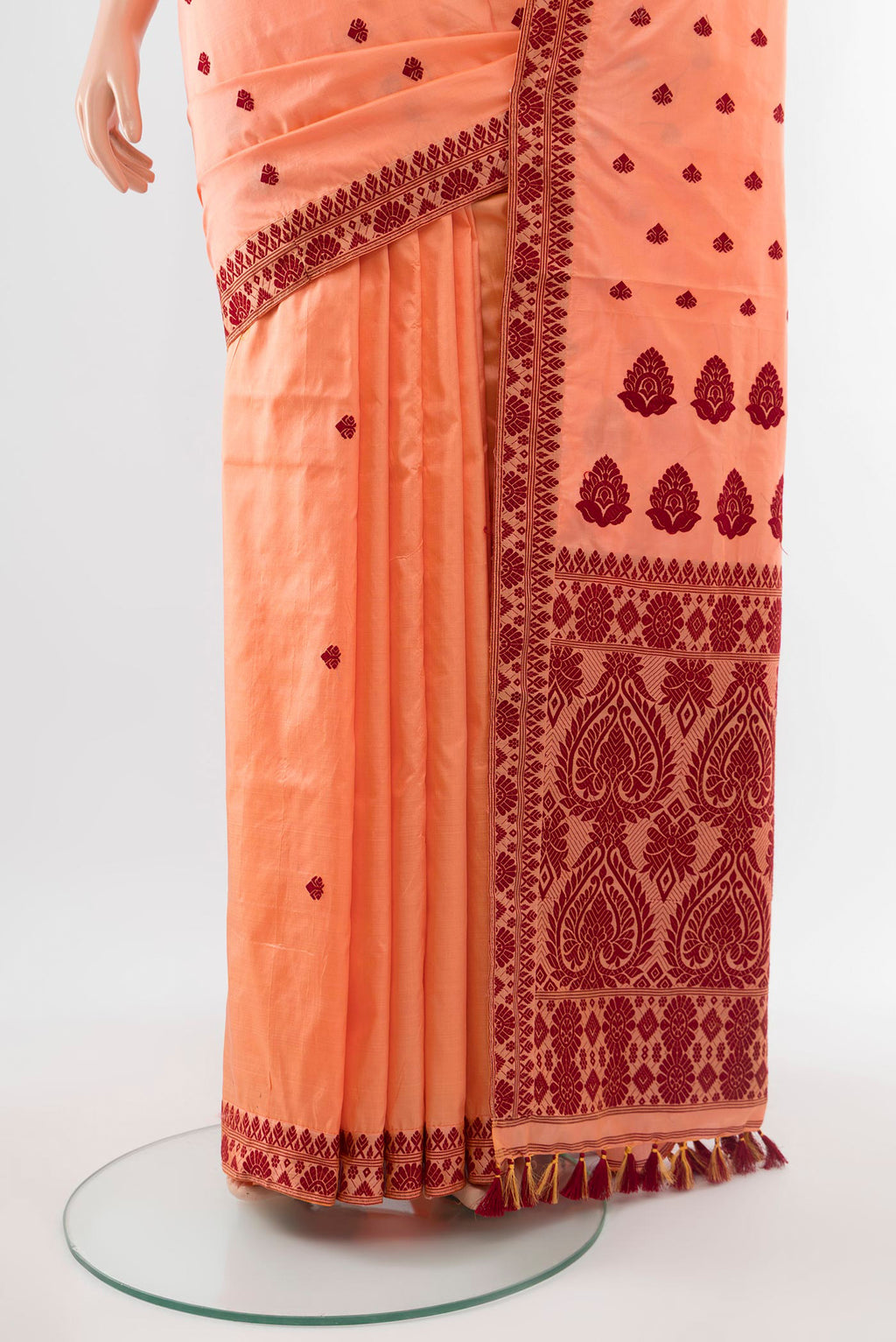 Pleats and pallu of Orange Assam Silk Saree with Jacquard With Thread Butta on the body and Silk Border. 