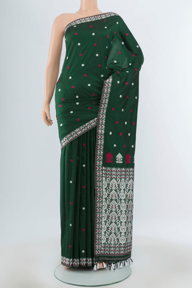 Bottle Green Assam Silk Saree with Jacquard With Thread Butta on the body and Silk Border.  displayed on a mannequin
