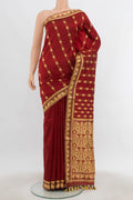 Maroon Assam Silk Saree with Thread Butta on the body and Silk Border.  displayed on a mannequin