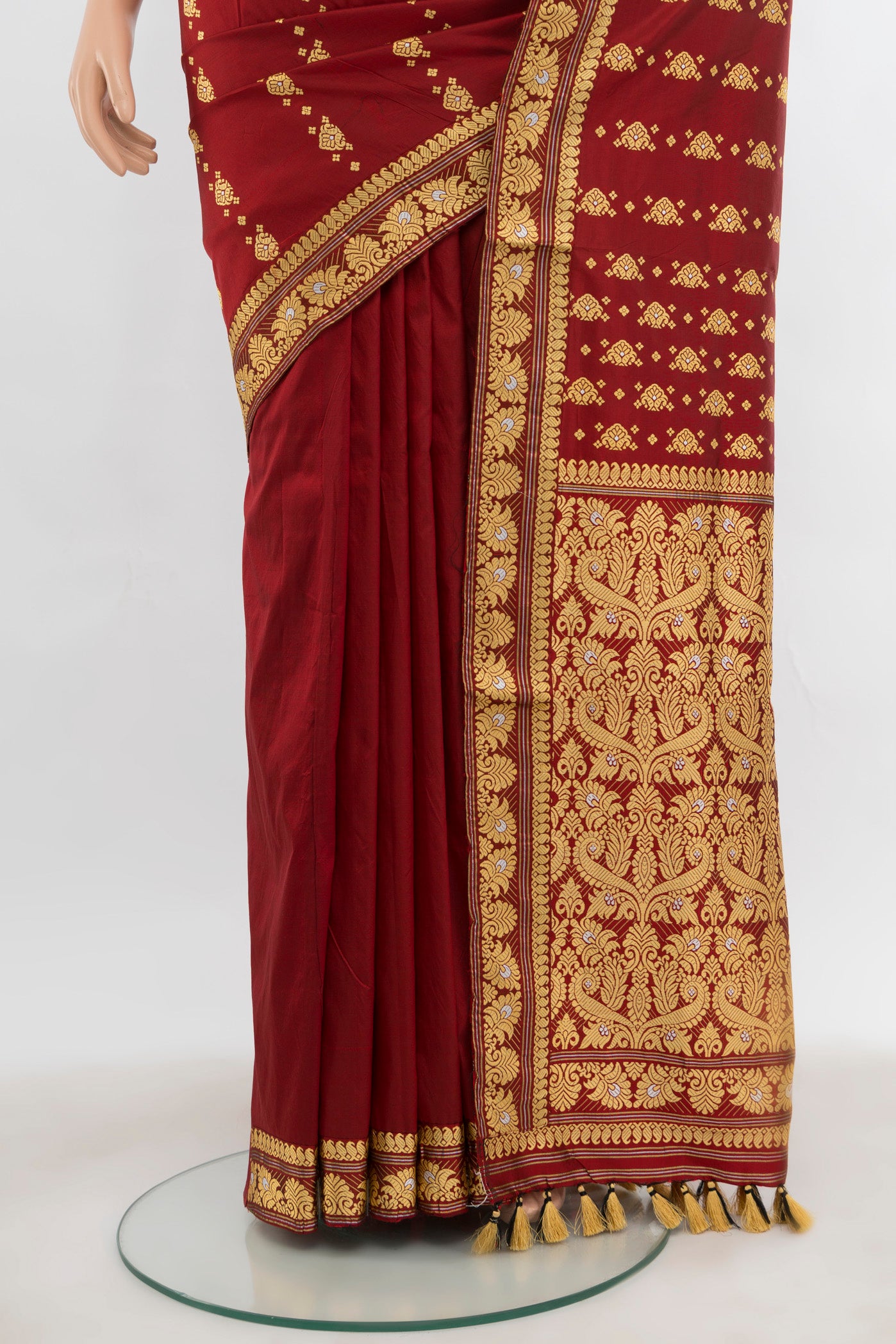 Pleats and pallu of Maroon Assam Silk Saree with Thread Butta on the body and Silk Border. 