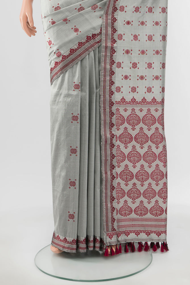 Pleats and pallu of Grey Assam Silk Saree with Zari Butta on the body and Silk Border. 