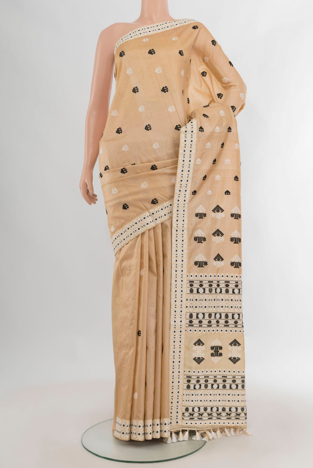 Pure Silk Beige Assam Saree with Thread Butta on the body and Thread Border.  displayed on a mannequin
