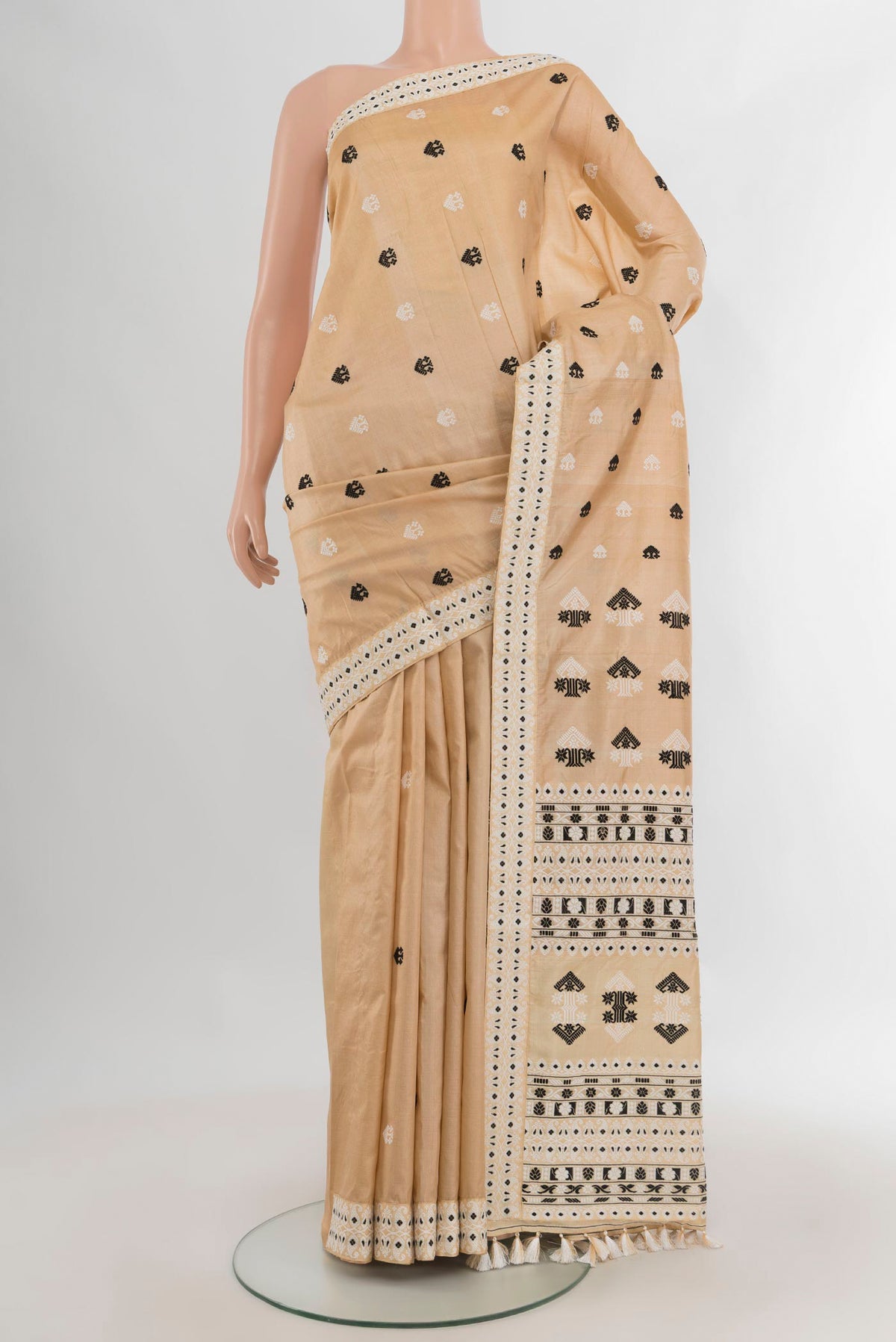 Pure Silk Beige Assam Saree with Thread Butta on the body and Thread Border.  displayed on a mannequin