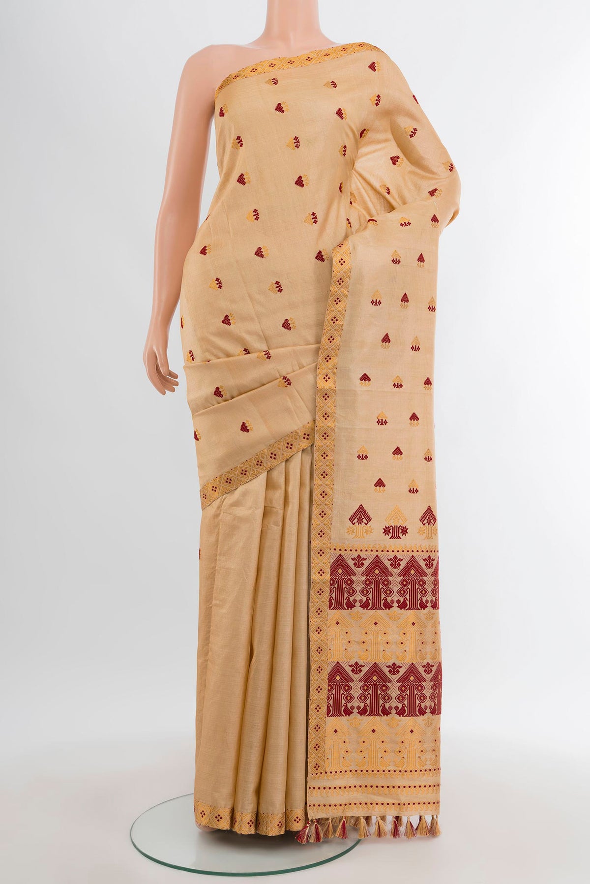 Sandal Assam Silk Saree with Thread Butta on the body and Thread Border.  displayed on a mannequin