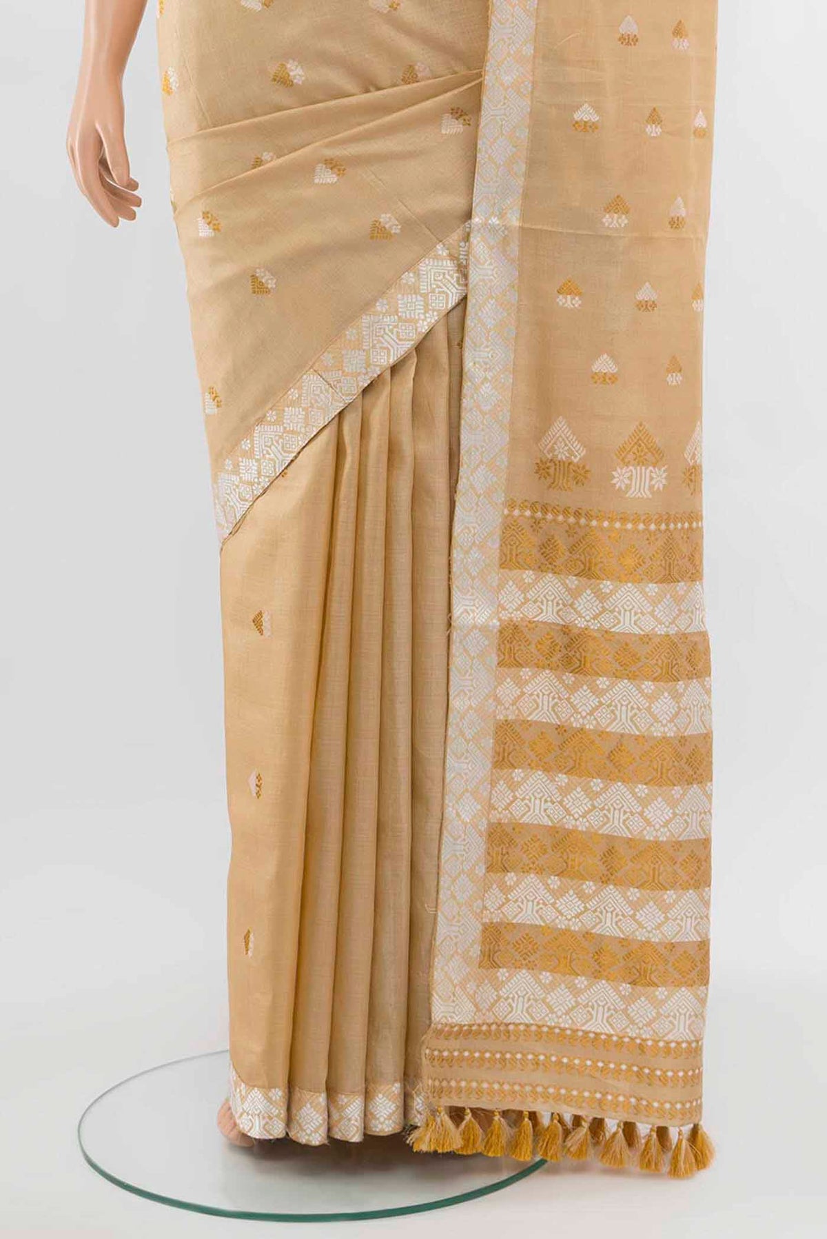 Pleats and pallu of Beige Assam Silk Saree with Zari Butta on the body and Silk Border