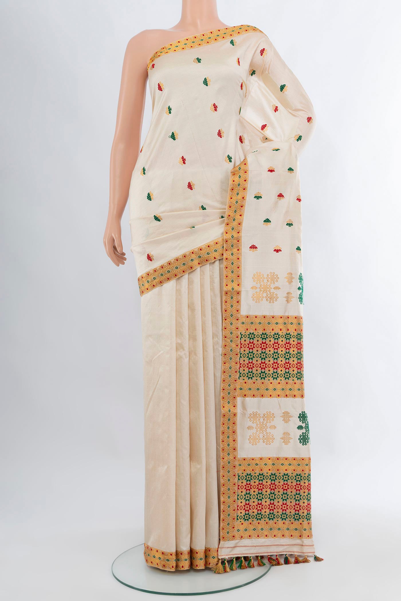 Off White Assam Silk Saree with Thread Butta on the body and Thread Border.  displayed on a mannequin