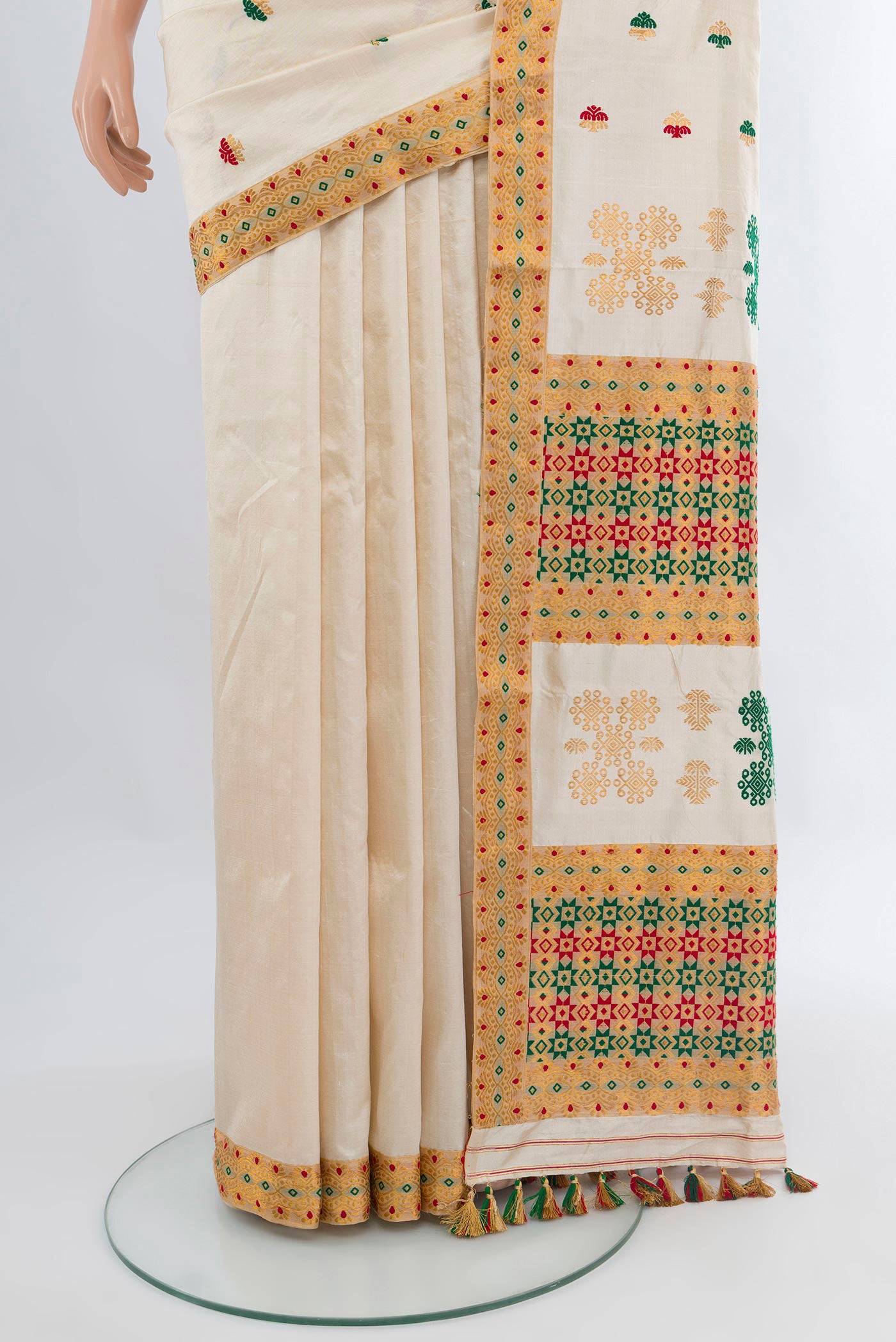 Pleats and pallu of Off White Assam Silk Saree with Thread Butta on the body and Thread Border. 