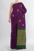 Pure Silk Pure Zari Violet Kanchipuram Saree with Zari Butta on the body and Silk Border.  displayed on a mannequin