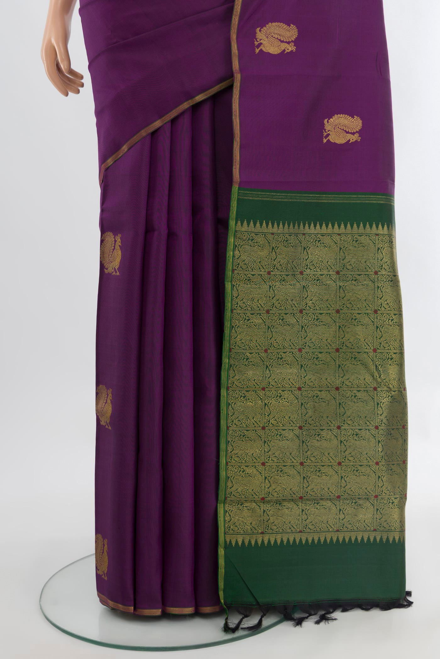 Pleats and pallu of Pure Silk Pure Zari Violet Kanchipuram Saree with Zari Butta on the body and Silk Border. 