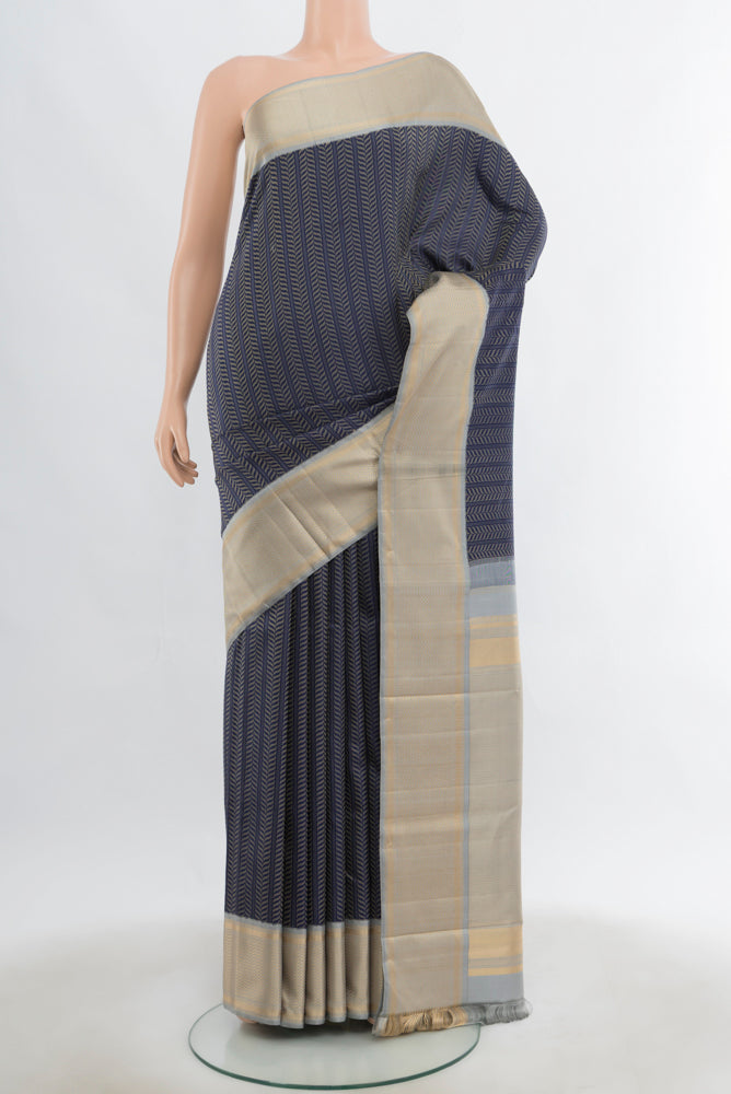 Navy Blue Kanchipuram Silk Saree with Zari Butta on the body and Silk Border.  displayed on a mannequin