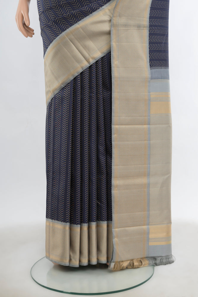 Pleats and pallu of Navy Blue Kanchipuram Silk Saree with Zari Butta on the body and Silk Border. 
