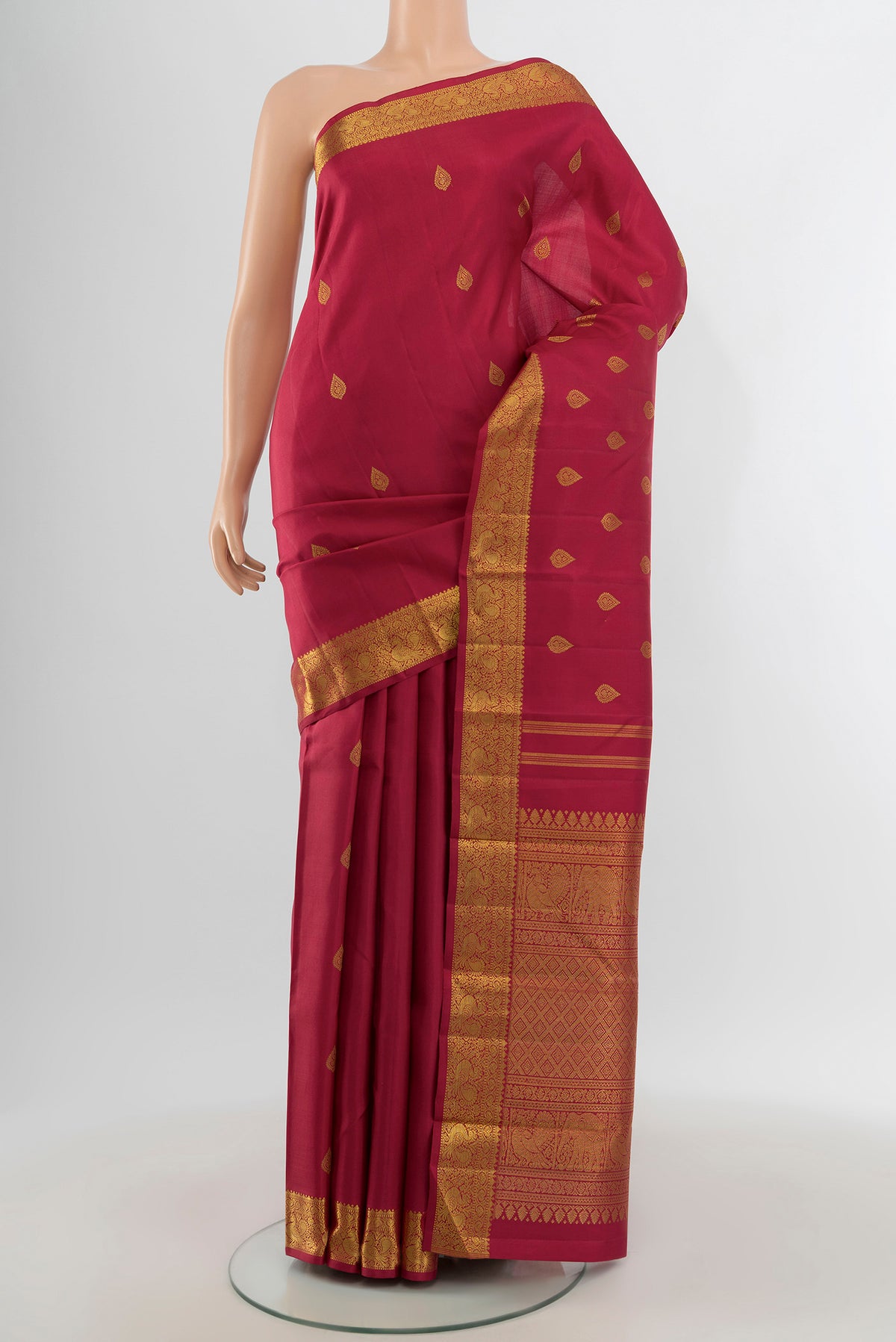 Pure Silk Pure Zari Maroon Kanchipuram Saree with Zari Butta on the body and Zari Border.  displayed on a mannequin