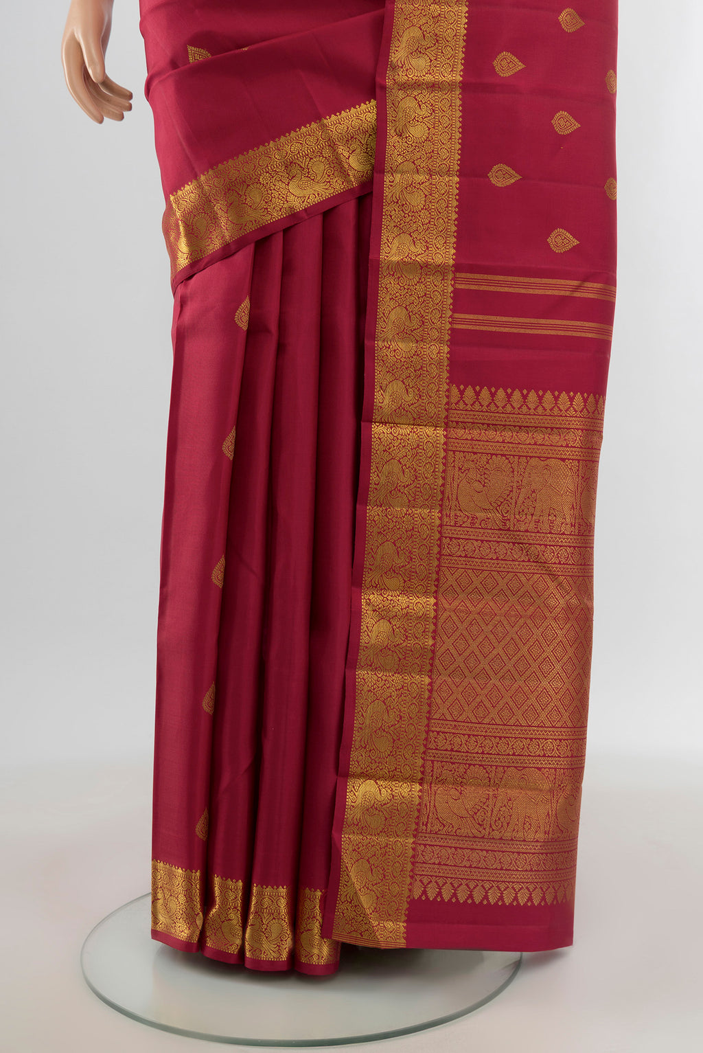 Pleats and pallu of Pure Silk Pure Zari Maroon Kanchipuram Saree with Zari Butta on the body and Zari Border. 