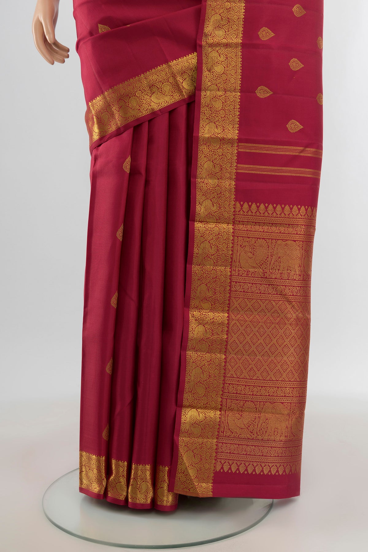 Pleats and pallu of Pure Silk Pure Zari Maroon Kanchipuram Saree with Zari Butta on the body and Zari Border. 