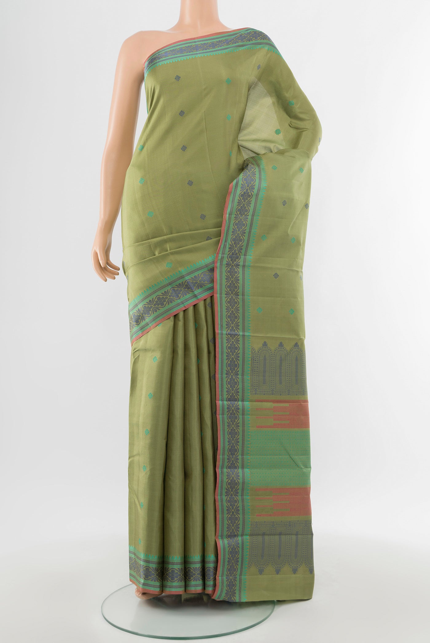 Pure Silk Pure Zari Light Green Kanchipuram Saree with Zari Butta on the body and Silk Border.  displayed on a mannequin