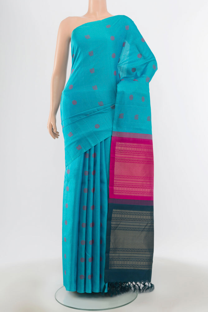 Pure Silk Pure Zari Sky Blue Kanchipuram Saree with Zari Butta on the body and Silk Border.  displayed on a mannequin