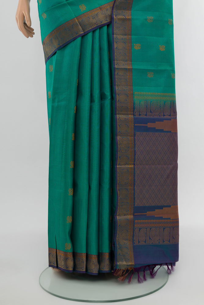 Pleats and pallu of Peacock Blue Kanchipuram Silk Saree with Zari Butta on the body and Silk Border. 