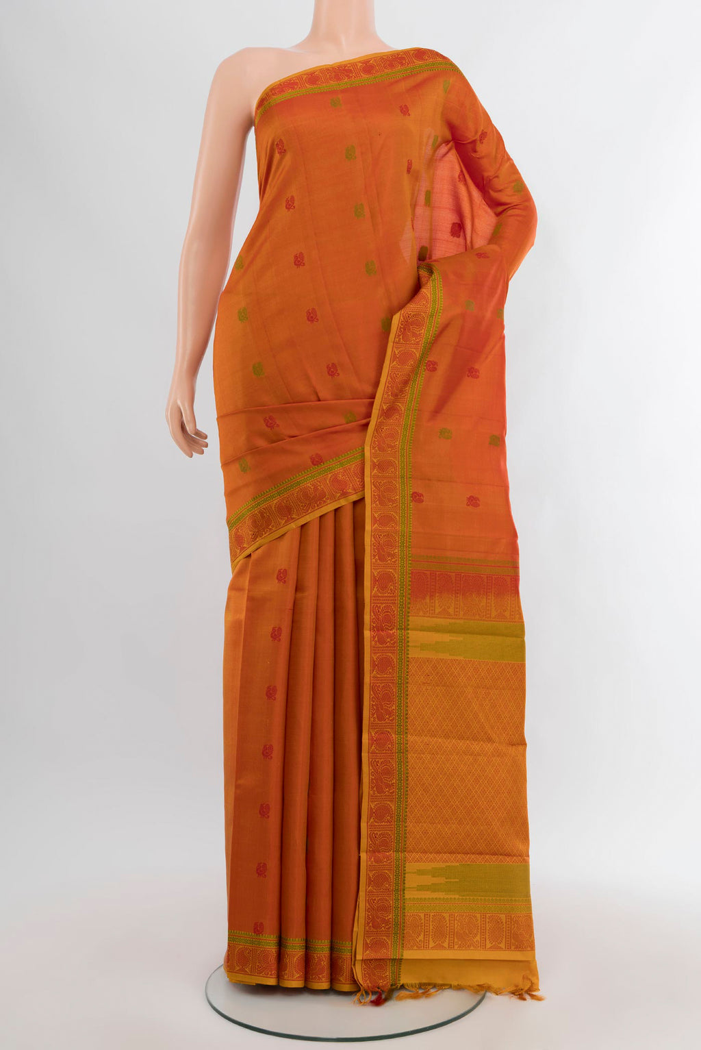 Brick Orange Kanchipuram Silk Saree with Thread Butta on the body and Thread Border.  displayed on a mannequin