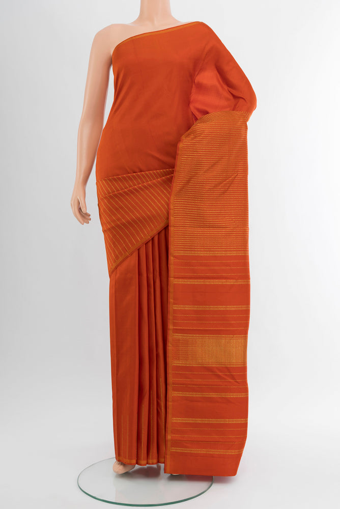 Pure Silk Pure Zari Rust Kanchipuram Saree with Zari Butta on the body and Silk Border.  displayed on a mannequin