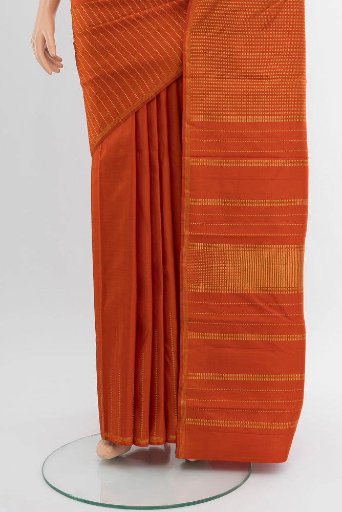 Pleats and pallu of Pure Silk Pure Zari Rust Kanchipuram Saree with Zari Butta on the body and Silk Border. 