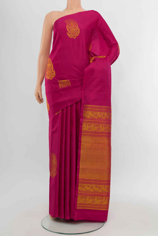 Dark Pink Kanchipuram Silk Saree with Zari Butta on the body and Silk Border.  displayed on a mannequin