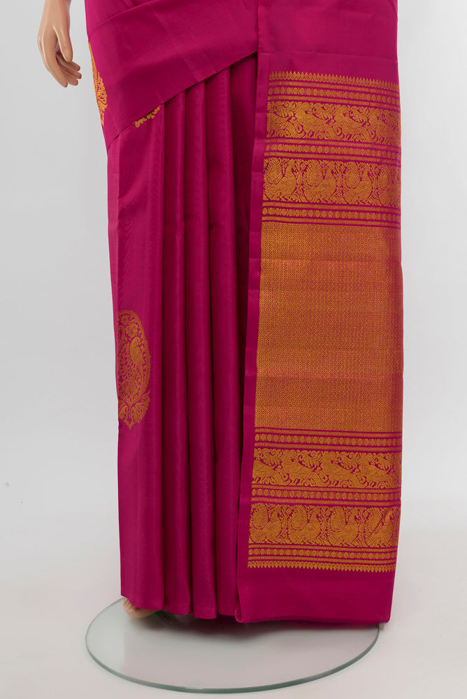 Pleats and pallu of Dark Pink Kanchipuram Silk Saree with Zari Butta on the body and Silk Border. 