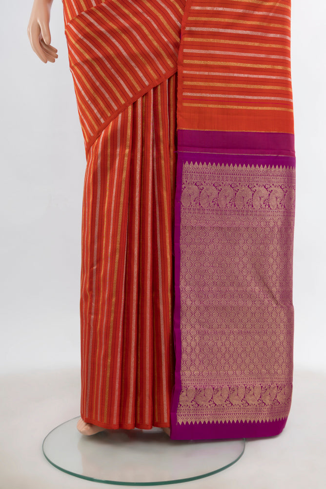 Pleats and pallu of Rust Kanchipuram Silk Saree with Zari Butta on the body and Fancy Border. 