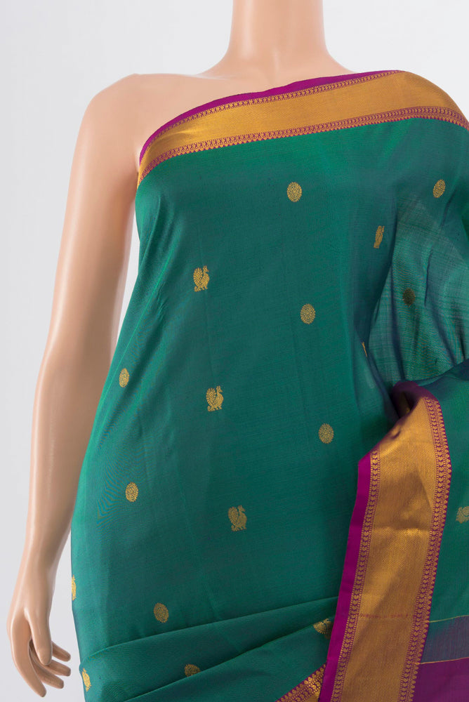 Border image of Peacock Blue Kanchipuram Silk Saree with Zari Butta on the body and Silk Border. 
