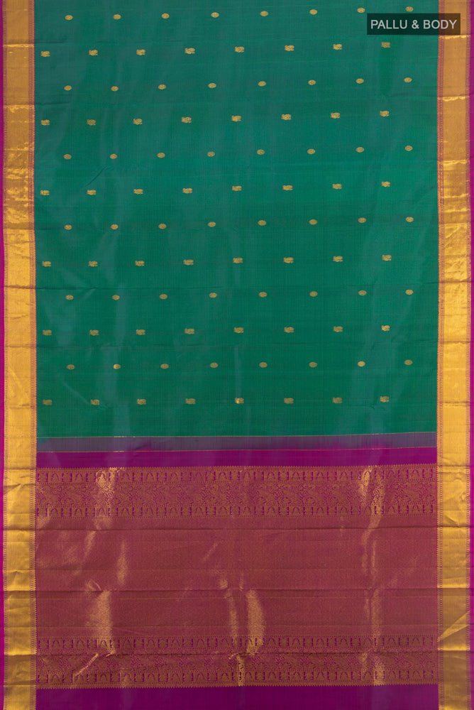 Flat view of Peacock Blue Kanchipuram Silk Saree with Zari Butta on the body and Silk Border. 
