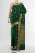 Pure Silk Pure Zari Bottle Green Kanchipuram Saree with Zari Butta on the body and Silk Border.  displayed on a mannequin